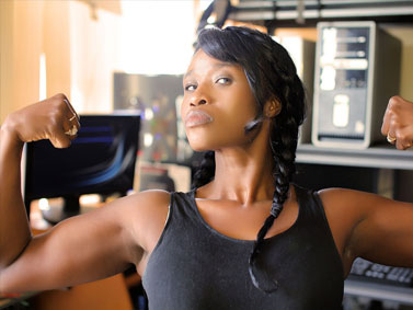 African-American woman flexing her biceps with a strong facial expression. An example of a woman who chooses nurse-midwifery care for well-woman/well-person, sexual and reproductive healthcare in Connecticut.